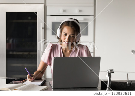 Young woman studying using laptop and educational online platform Young woman studying using laptop and educational online platform 123923611