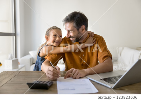 Father reviewing household budget while daughter embraces him 123923636