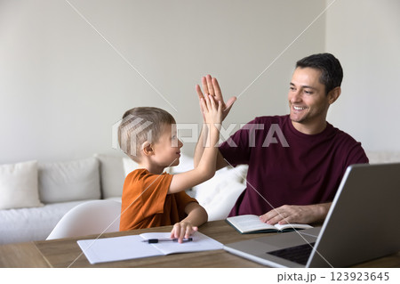 Dad encourages little school age son with great study results 123923645
