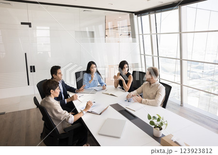 Diverse multicultural entrepreneurs gather around table to collaborate on project 123923812