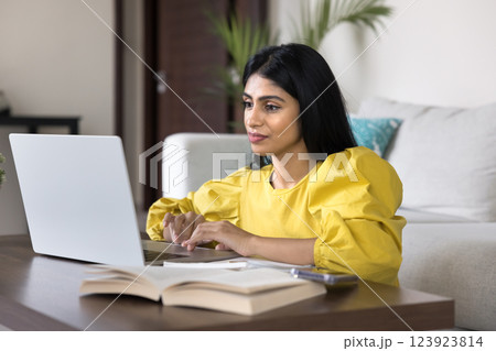 Indian woman studying, researching or doing professional work using laptop Indian woman studying, researching or doing professional work using laptop 123923814