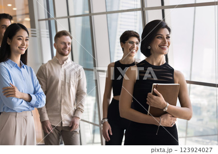 Smiling multiethnic employees with mature female boss posing at office Smiling multiethnic employees with mature female boss posing at office 123924027