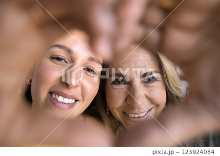 Family showing to camera heart symbol with joined fingers 123924084