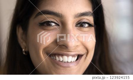 Cropped face view, young pretty Indian woman looks at camera 123924155
