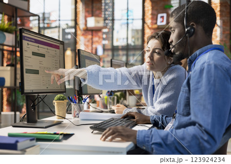 Call center agents collaborating to solve problem for customer, tracking lost shipments in office. Customer center colleagues working together using software to locate clients packages Call center agents collaborating to solve problem for customer, tracking lost shipments in office. Customer center colleagues working together using software to locate clients packages 123924234
