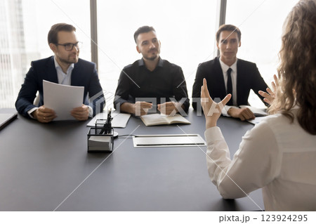 Young girl applicant interviewing for position by group of hr Young girl applicant interviewing for position by group of hr 123924295