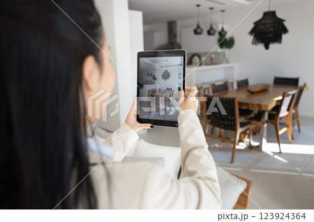 Young Asian real estate agent woman taking pictures of house Young Asian real estate agent woman taking pictures of house 123924364