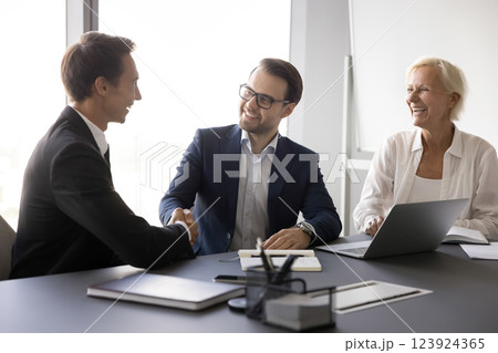Two hr managers recruit applicant confirm successful placement with handshaking 123924365