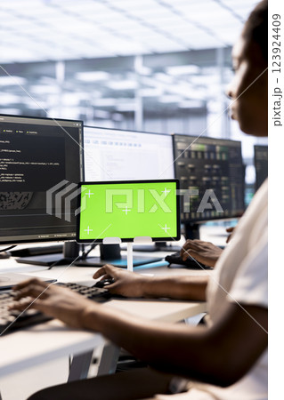 Computer scientist using green screen tablet to check for signs of failure in data center mainframes. IT expert working on mockup device to prevent damages in server room, monitoring network 123924409