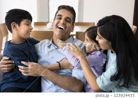 Indian family tickling each other, having fun, laughing on weekend Indian family tickling each other, having fun, laughing on weekend 123924435
