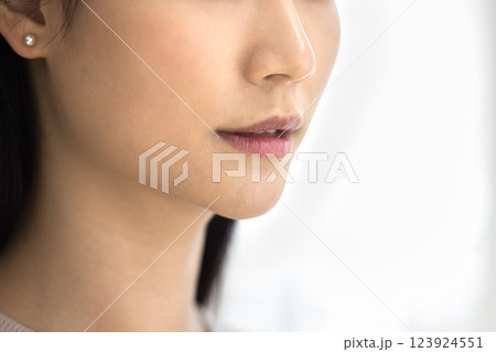 Close up shot of young beautiful Asian womans lower face 123924551