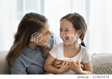 Affectionate mom tickle laughing little girl share fun with child 123924578