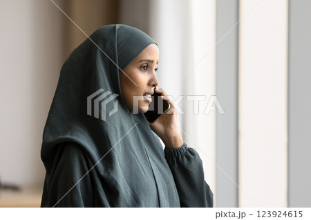 Young Arabian businesswoman engaged in business phone conversation 123924615