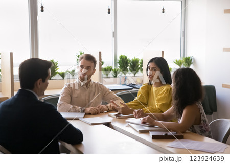 Small group multiethnic young students listen to teacher on consultation 123924639