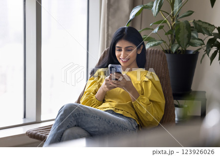 Indian woman spend free time on internet using modern smartphone 123926026