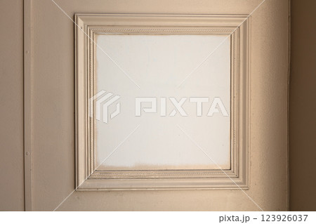 Empty Vintage Square Picture Frame on Beige Wall 123926037