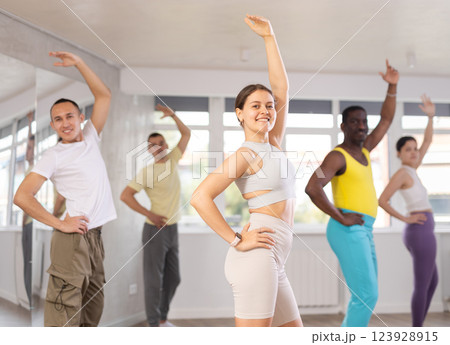 Young woman practicing aerobic dance in training hall Young woman practicing aerobic dance in training hall 123928915