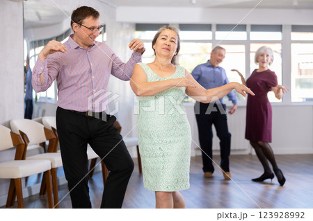 Adult man and elderly woman dance twist 123928992