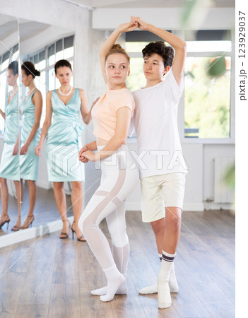 Girl and boy dancing slow ballroom dance in choreography studio Girl and boy dancing slow ballroom dance in choreography studio 123929037