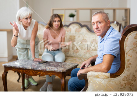 Relatives express displeasure to the father of the family in room at home 123929072