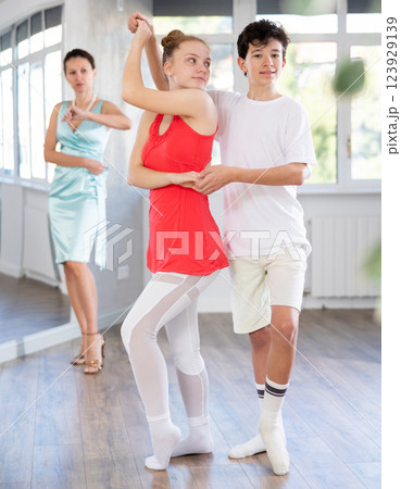 Girl and boy dancing slow ballroom dance in choreography studio 123929139