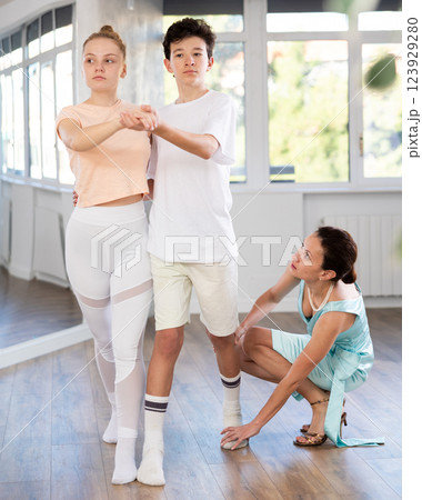 Girl and a boy are having fun learning to dance tango at choreographic school Girl and a boy are having fun learning to dance tango at choreographic school 123929280