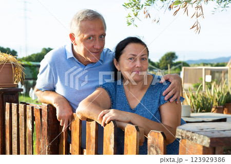 Portrait of positive mature couple in garden outdoors 123929386