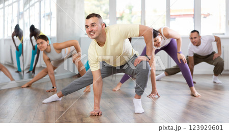 Group of people warming up before dance class Group of people warming up before dance class 123929601