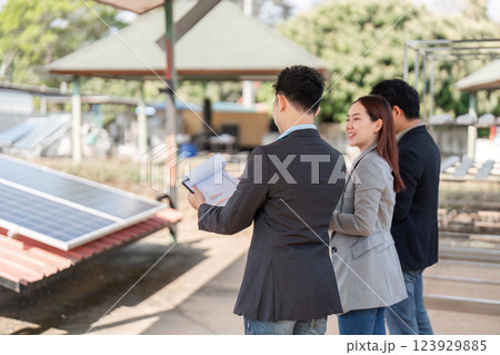 Sustainable business. Team analyzing solar panels and discussing strategies. 123929885