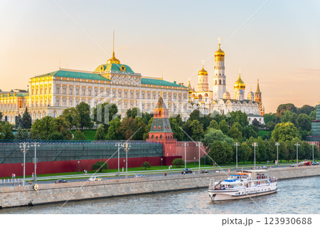 View of Kremlin with Vodovzvodnaya tower, Grand Kremlin Palace from repaired Bolshoy Kamenny Bridge in Moscow city on sunny summer day. Cruise ship sails on the Moscow river 123930688