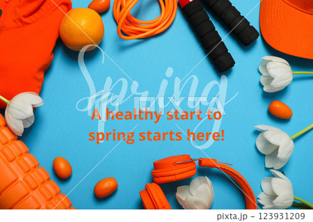 Hello spring, orange sportswear, equipment and white tulips on an blue background, top view, with text 123931209
