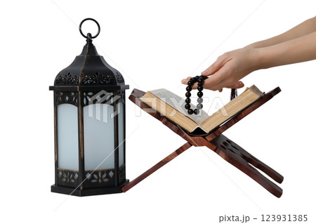 PNG, Ramadan. Quran book on a stand with a lantern, isolated on a white background. PNG, Ramadan. Quran book on a stand with a lantern, isolated on a white background. 123931385