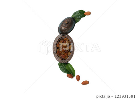 PNG, Ramadan. A bowl of raisins and almonds arranged in the shape of a moon, isolated on a white background. 123931391