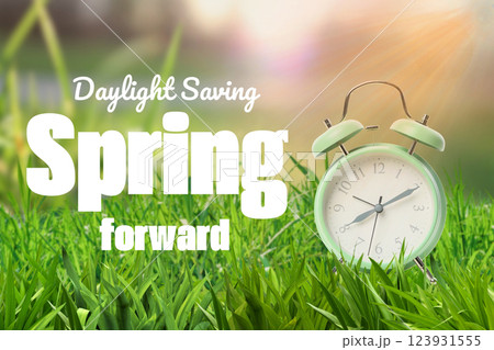 Spring Forward. Design, alarm clock with inscription on grass. Spring Forward. Design, alarm clock with inscription on grass. 123931555