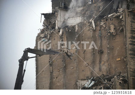 Demolition Process of an Industrial Building Using Excavator Equipment Demolition Process of an Industrial Building Using Excavator Equipment 123931618