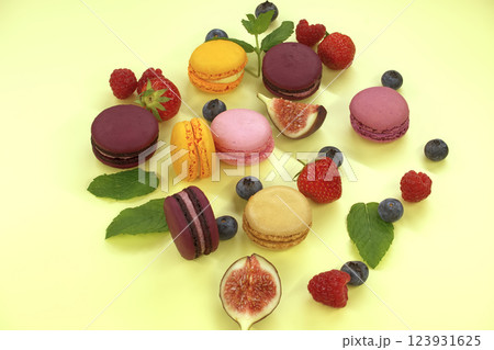 Table filled with array of macaroons and fruits 123931625