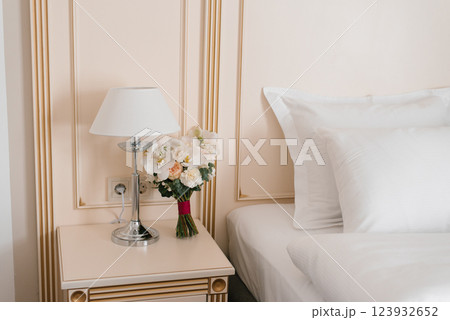 Fresh Flowers Arrangement on Nightstand with Lamp 123932652