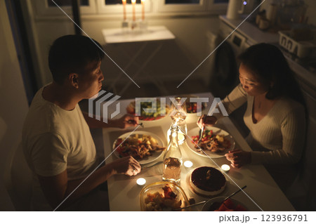 Couple enjoying romantic candlelit dinner at home Couple enjoying romantic candlelit dinner at home 123936791