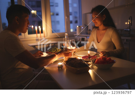 Young couple enjoying romantic candlelit dinner at home Young couple enjoying romantic candlelit dinner at home 123936797