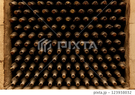 Old bottles of wine stacked in rows 123938032