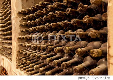 Old bottles of wine stacked in rows Old bottles of wine stacked in rows 123938126