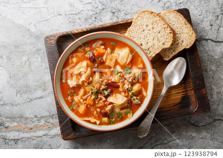 Winter Ground beef cabbage tomato soup with vegetables close-up in a bowl on the table. Horizontal top view Winter Ground beef cabbage tomato soup with vegetables close-up in a bowl on the table. Horizontal top view 123938794