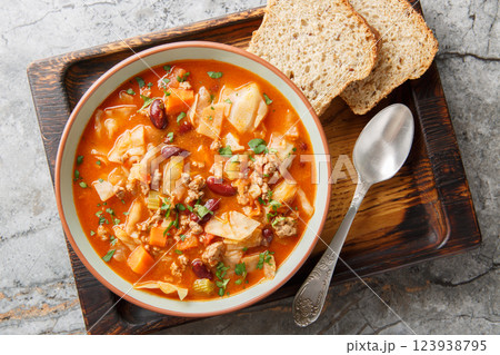 Italian sausages cabbage tomato soup with vegetables close-up in a bowl. Horizontal top view Italian sausages cabbage tomato soup with vegetables close-up in a bowl. Horizontal top view 123938795