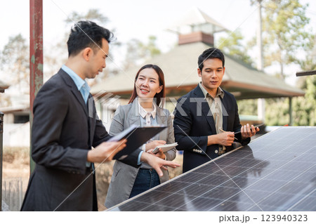 Innovative energy assessment. Diverse professionals collaborating on solar technology for business sustainability. Innovative energy assessment. Diverse professionals collaborating on solar technology for business sustainability. 123940323