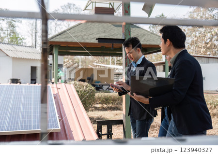 Sustainable business practices. Professionals discussing solar energy solutions outdoors. 123940327