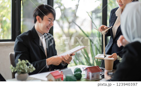 Collaboration and Sustainability. A team reviewing their sustainable project with enthusiasm and dedication. 123940397