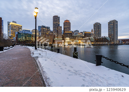 View of Boston downtown skyscrapers seen from Fan Pier Park on a cold cloudy winter night View of Boston downtown skyscrapers seen from Fan Pier Park on a cold cloudy winter night 123940629