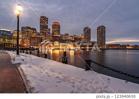 View of Boston downtown  skyscrapers seen from Fan Pier Park on a cold cloudy winter night 123940630