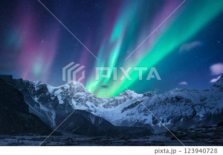 Northern lights over the snowy mountains at night in Norway Northern lights over the snowy mountains at night in Norway 123940728