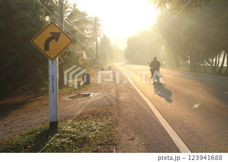 right turn sign with rural people and morning light right turn sign with rural people and morning light 123941688